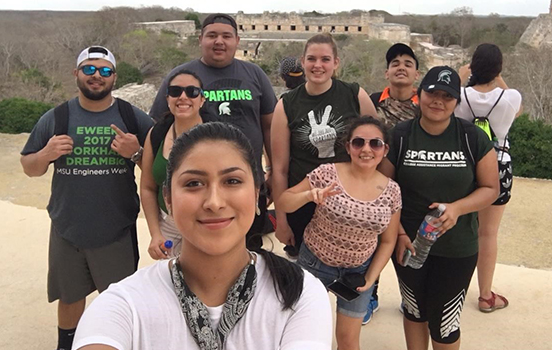 Group of students standing on top of Mayan ruin in Mexico