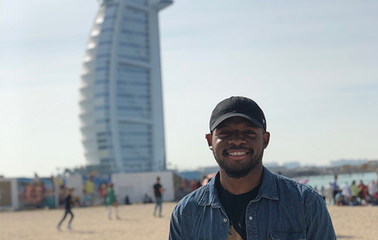 Student standing in front of building in Dubai, United Arab Emirates