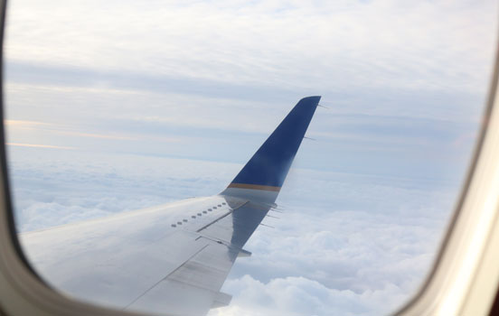 Photo looking out into the sky from airplane window