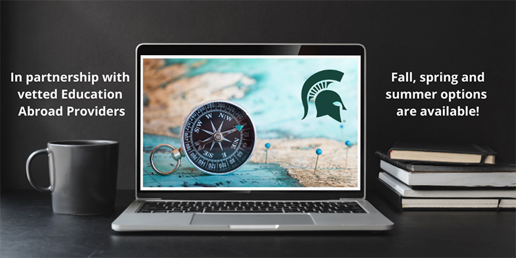 Open laptop with map, compass and Spartan head on screen