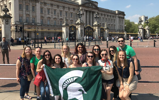Students holding Spartan flag in front of Buckingham Palace in London, England